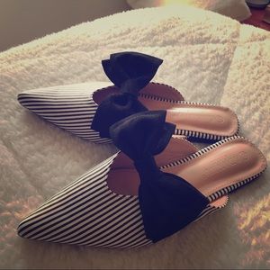 Black and white striped slides with black bow